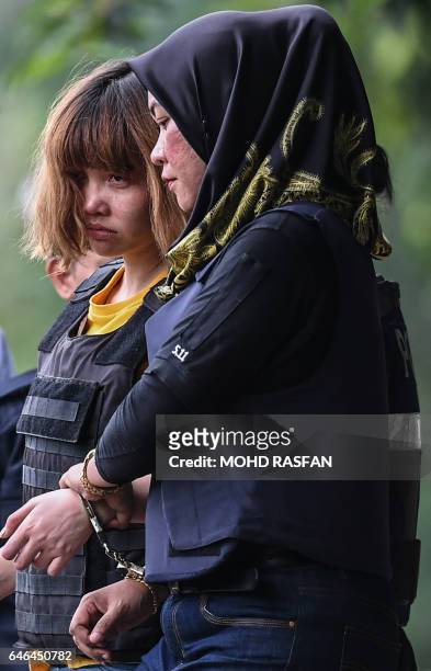 Vietnamese national Doan Thi Huong is escorted with a heavy police presence after a court appearance with Indonesian national Siti Aisyah at the...