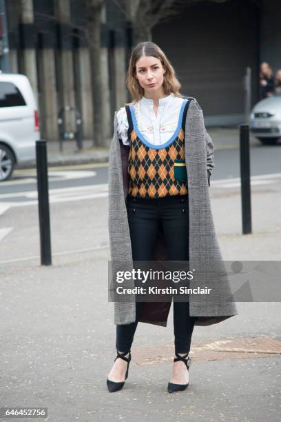 Fashion Blogger Irina Lakicevic wears Louis Vuitton shoes, Isabel Marant trousers and jacket, Miu Miu sweater on day 2 of London Womens Fashion Week...