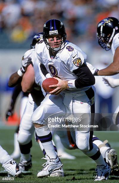 Quarterback Trent Dilfer of the Baltimore Ravens moves back with the ball during the game against the Cincinnati Bengals at Brown Stadium in...
