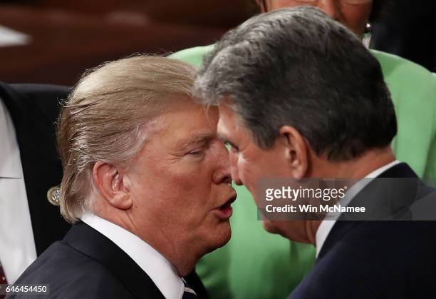President Donald Trump speaks with Sen. Joe Manchin after addressing a joint session of the U.S. Congress on February 28, 2017 in the House chamber...