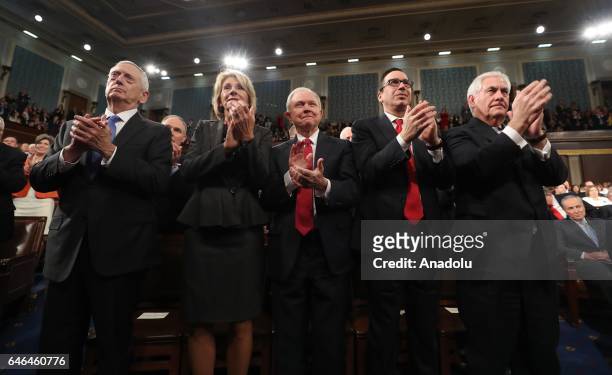 Cabinet members James Mattis, Betsy DeVos, Jeff Sessions, Steve Mnuchin and Rex Tillerson applaud as US President Donald J. Trump delivers his first...