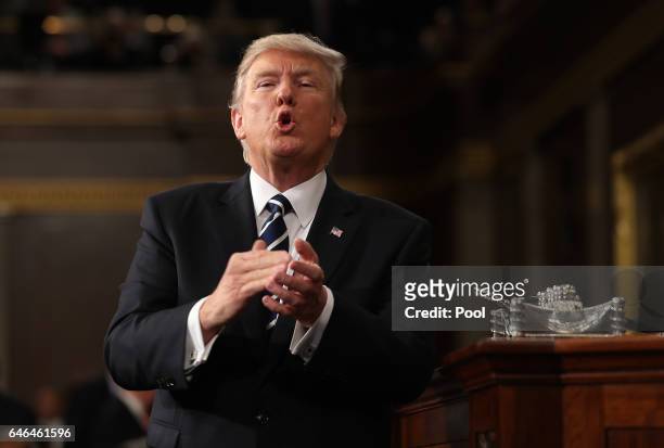 President Donald Trump reacts after delivering his first address to a joint session of the U.S. Congress on February 28, 2017 in the House chamber of...