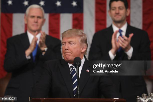 Vice President Mike Pence and Speaker of the House Paul Ryan applaud as US President Donald J. Trump arrives to deliver his first address to a joint...