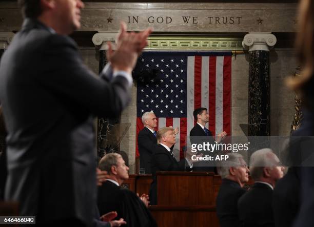 President Donald J. Trump and the entire chamber reacts towards Carryn Owens, widow of Navy Seal Ryan Owens, as Trump delivers his first address to a...