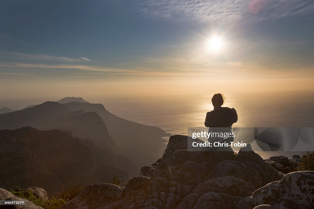 Silhouette of woman sitting at Table Mountain