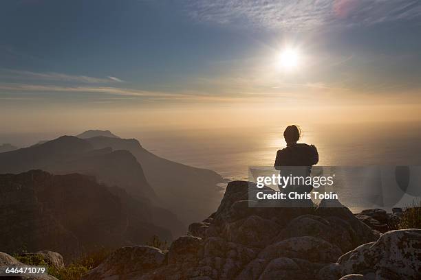 silhouette of woman sitting at table mountain - cape town sunset stock pictures, royalty-free photos & images