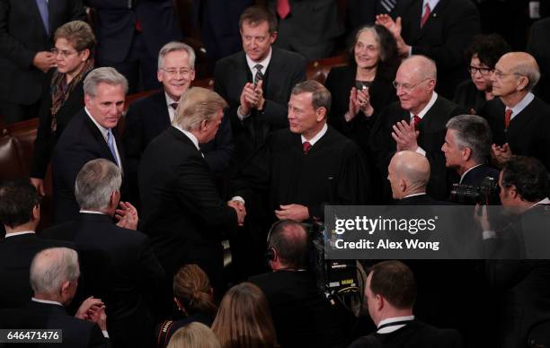 President Donald Trump shakes hands with Supreme Court Chief Justice John Roberts during a joint session of the U.S. Congress on February 28, 2017 in...