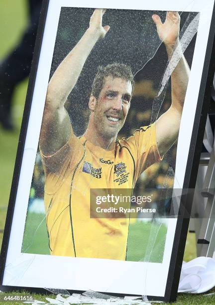 Photograph of the late Dan Vickerman is seen after it was broken by winds during the Public Memorial for former Australian Rugby Union player Dan...