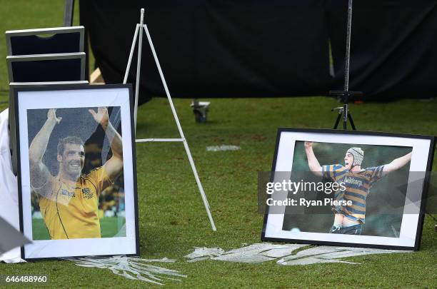 Framed photographs of the late Dan Vickerman are seen after they were broken by winds during the Public Memorial for former Australian Rugby Union...