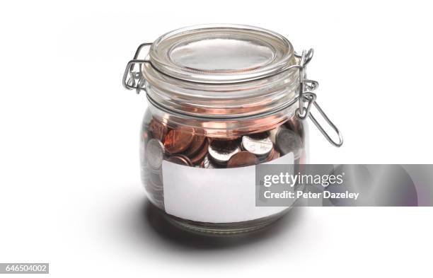 jar of coins with copy space - saving for a rainy day englische redewendung stock-fotos und bilder