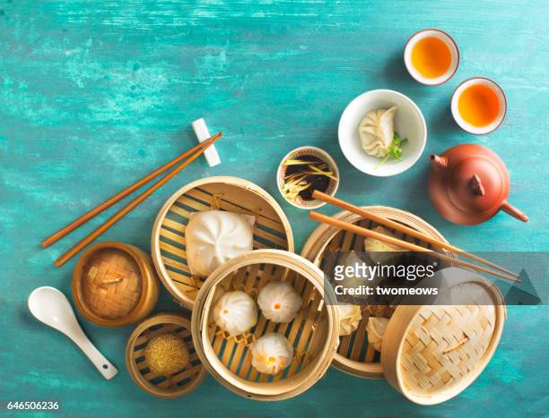 chinese food dumpling and tea set on rustic table top. - dimsum stock pictures, royalty-free photos & images