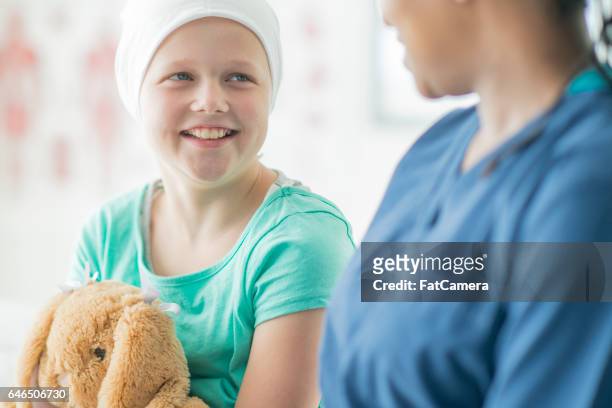 helping a child through chemo - childhood cancer stock pictures, royalty-free photos & images