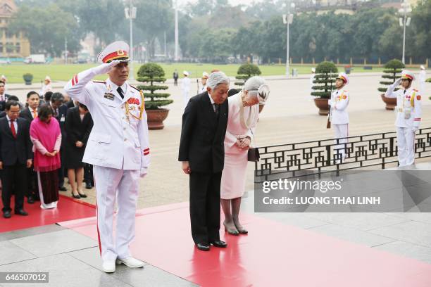 Japan's Emperor Akihito and Empress Michiko attend a wreath laying ceremony at the mausoleum of Vietnam's late president Ho Chi Minh in Hanoi on...