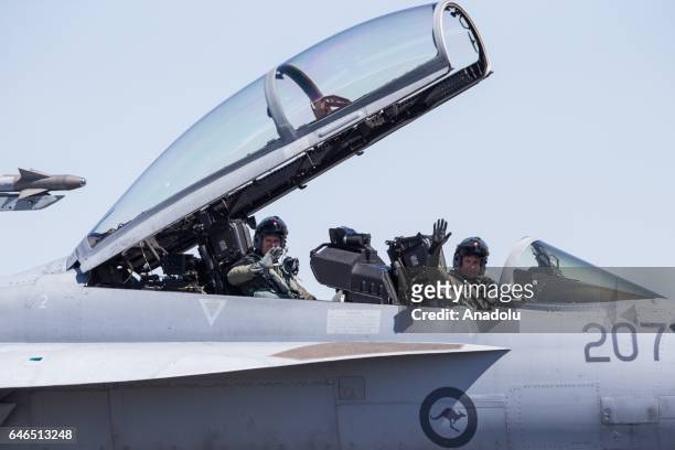 Super Hornet by Boeing operated by the ADF landed taxi's on the runway with its hatch and wings lifted up as the pilots wave to the crowd during the...