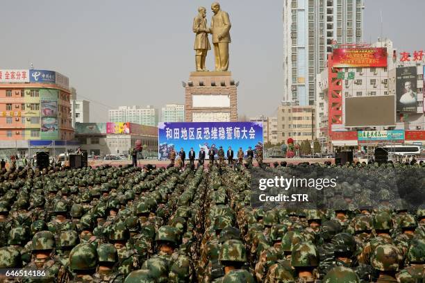 This photo taken on February 27, 2017 shows Chinese military police attending an anti-terrorist oath-taking rally in Hetian, northwest China's...