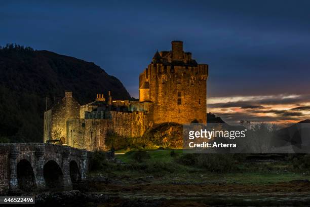 Illuminated Eilean Donan Castle at night in Loch Duich, Ross and Cromarty, Western Highlands of Scotland, UK.