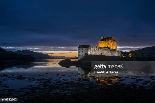 Illuminated Eilean Donan Castle at night in Loch Duich, Ross and Cromarty, Western Highlands of Scotland, UK.