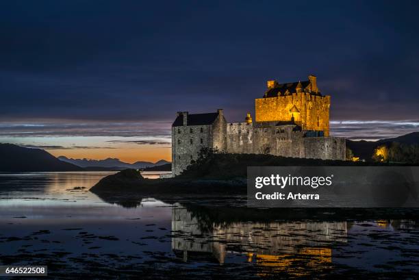 Illuminated Eilean Donan Castle at night in Loch Duich, Ross and Cromarty, Western Highlands of Scotland, UK.