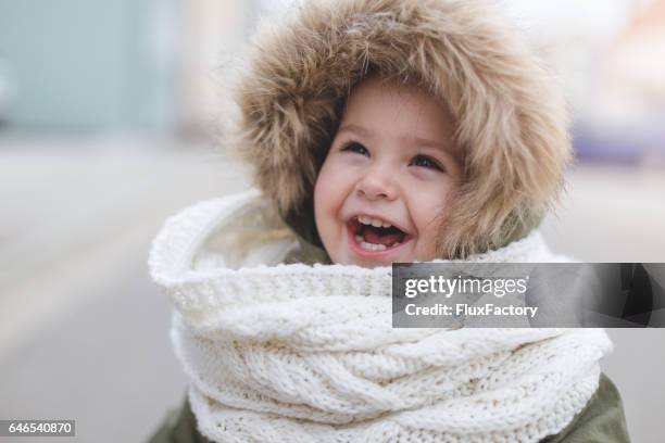 happy toddler girl laughing - winter fashion - winter baby stock pictures, royalty-free photos & images