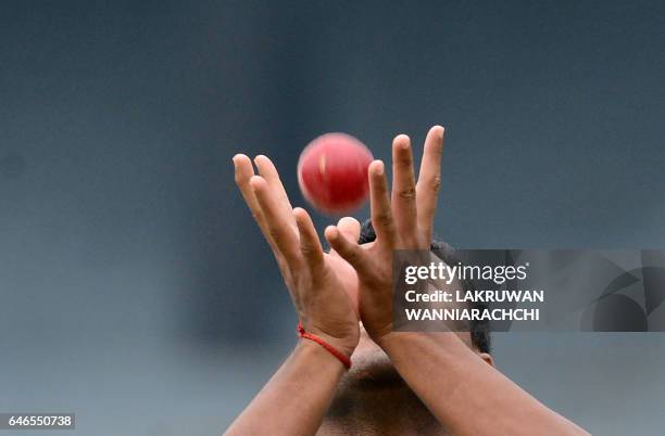 Bangladesh cricketer Subashis Roy catches a ball during a practice session at the R. Premadasa Stadium in Colombo on March 1, 2017 ahead of a Test...