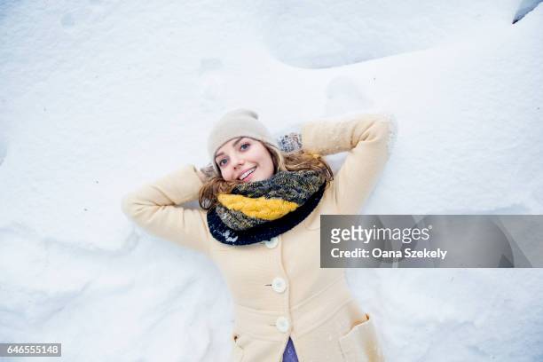 young woman enjoying the snow and the nature - spielerisch stock pictures, royalty-free photos & images