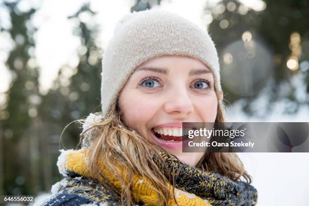 young woman enjoying the snow and the nature - spielerisch stock pictures, royalty-free photos & images