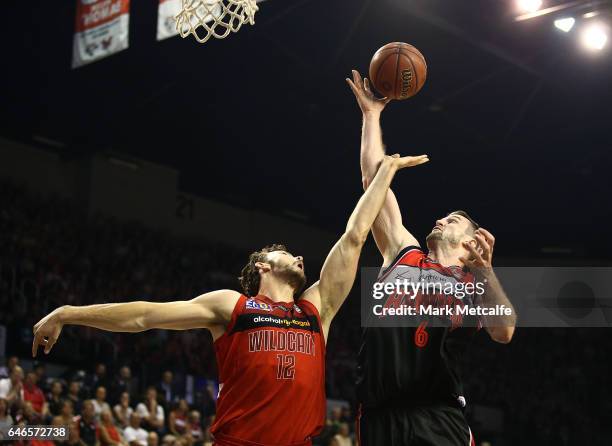 Angus Brandt of the WIldcats and Andrew Ogilvy of the Hawks compete for the ball during game two of the NBL Grand Final series between the Perth...