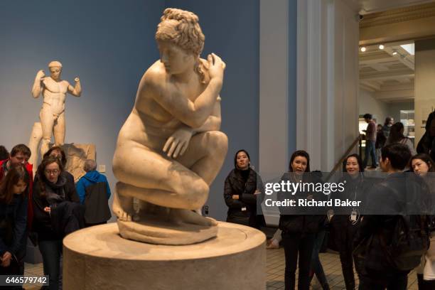 Women visitors admire the Hellenistic Crouching Aphrodite sculpture, on 28th February 2017, in the British Museum, London, England.