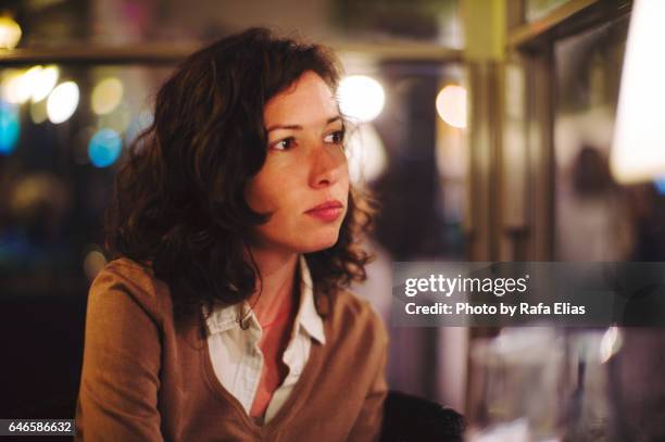 serious thoughtful woman indoors - view-through-restaurant-window stock pictures, royalty-free photos & images