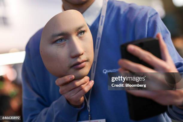 Worker demonstrates the Qualcomm Iris Authentication Solution on the Qualcomm Inc. Stand on the third day of Mobile World Congress in Barcelona,...