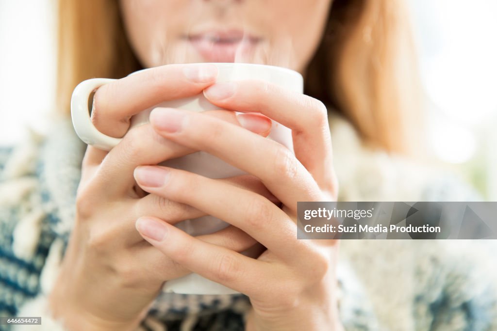 Woman drinking coffee.