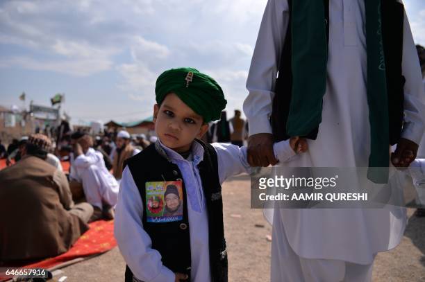 Young Pakistani Muslim stands outside the tomb of Mumtaz Qadri, who was hanged in February 2016 for the murder of a governor who criticized...