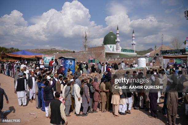 Pakistani Muslims stand in a queue to visit the tomb of Mumtaz Qadri, who was hanged in February 2016 for the murder of a governor who criticized...