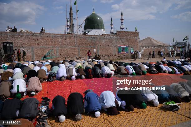 Pakistani Muslims offer noon prayers at the tomb of Mumtaz Qadri, who was hanged in February 2016 for the murder of a governor who criticized...