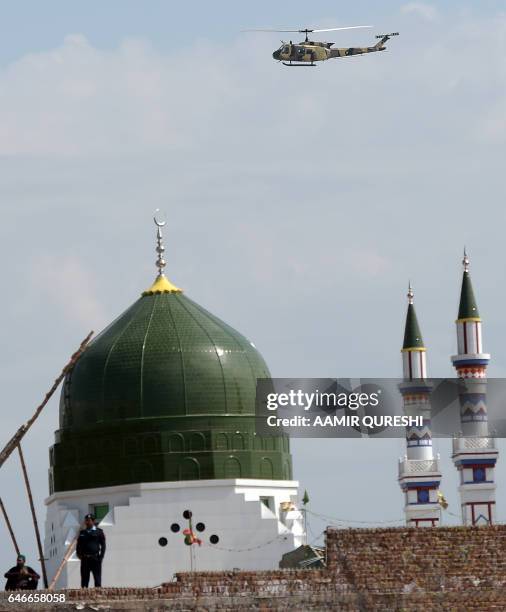 Pakistani security force helicopter patrols over the tomb of Mumtaz Qadri, who was hanged in February 2016 for the murder of a governor who...