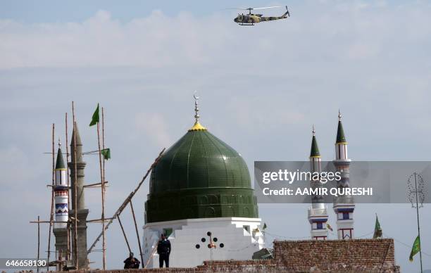 Pakistani security force helicopter patrols over the tomb of Mumtaz Qadri, who was hanged in February 2016 for the murder of a governor who...