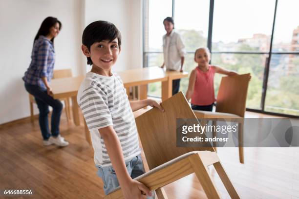 happy family moving home - moving furniture stock pictures, royalty-free photos & images