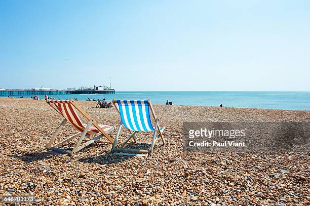 deck chairs on brighton beach - deckchair stock pictures, royalty-free photos & images
