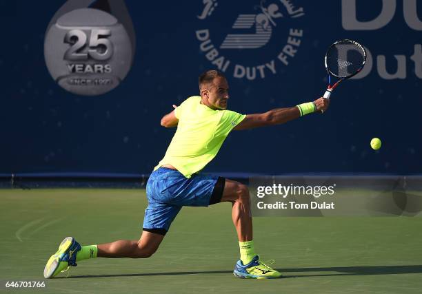 Marius Copil of Romania returns a shot during his second round match against Lucas Pouille of France on day four of the ATP Dubai Duty Free Tennis...