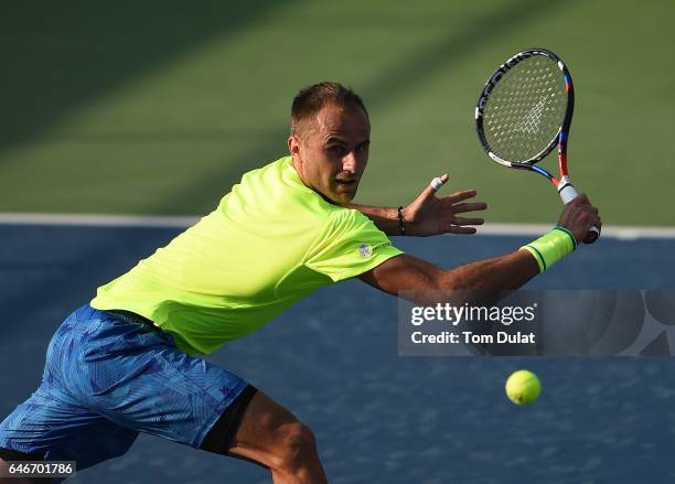 Marius Copil of Romania plays a backhand during his second round match against Lucas Pouille of France on day four of the ATP Dubai Duty Free Tennis...