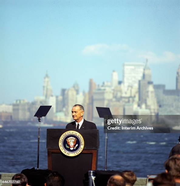 After signing a new Immigration Bill, American politician US President Lyndon Baines Johnson speaks at a podium on Liberty Island, New York, New...