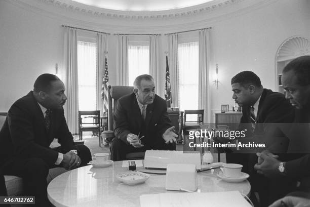 In the Oval Office at the White House, from left, American Civil Rights leader Reverend Martin Luther King Jr , US President Lyndon Baines Johnson...