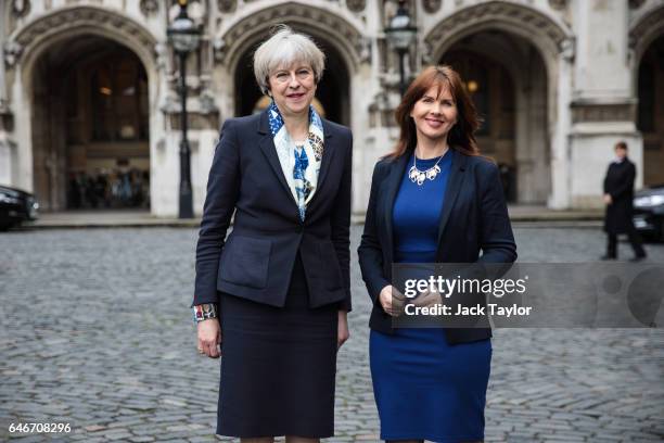 British Prime Minister Theresa May poses with newly elected Copeland MP Trudy Harrison outside the Houses of Parliament on March 1, 2017 in London,...