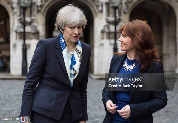 British Prime Minister Theresa May speaks with newly elected Copeland MP Trudy Harrison outside the Houses of Parliament on March 1, 2017 in London,...
