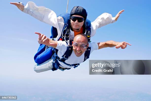 skydiving tandem enjoyment - skydive stock pictures, royalty-free photos & images