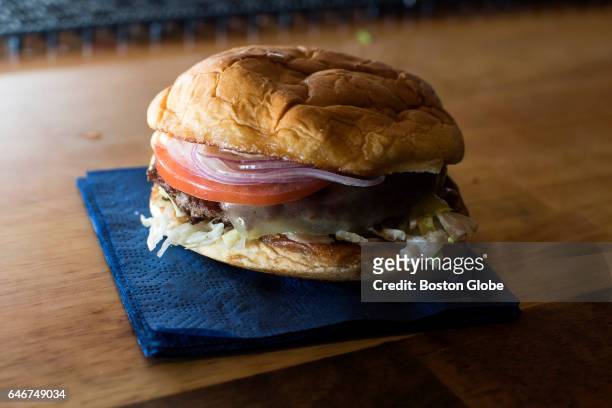 An LTO Burger, a burger with lettuce, tomato, onion, and Justins burger sauce, sits on a table at A4cade in Cambridge, MA on Feb. 23, 2017.