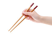Hand holding wooden chopsticks
