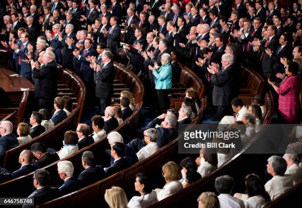 Democrats stay seated as Republicans give a standing ovation during President Donald Trump's address to a joint session of Congress on Tuesday, Feb....