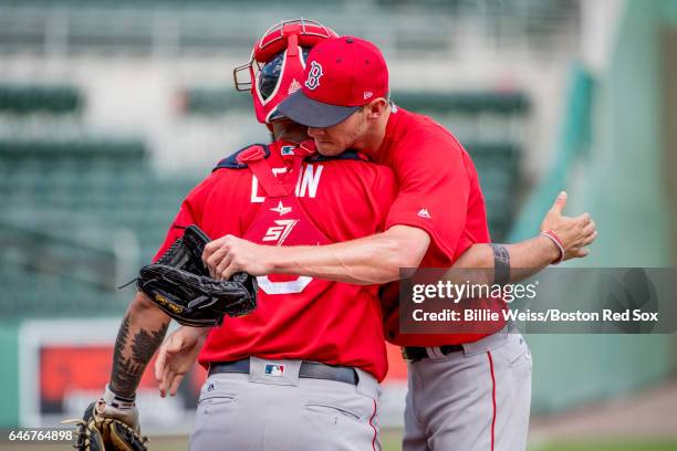 Chris Sale of the Boston Red Sox hugs Sandy Leon after throwing a simulated game during team workout on March 1, 2017 at Fenway South in Fort Myers,...