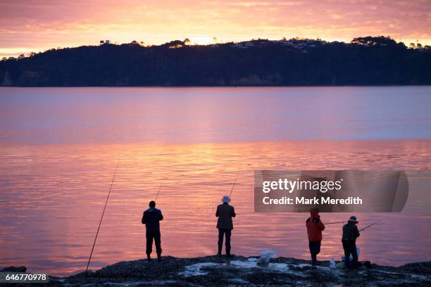 fishing at sunset on the waitemata harbour - waitemata harbor stock pictures, royalty-free photos & images